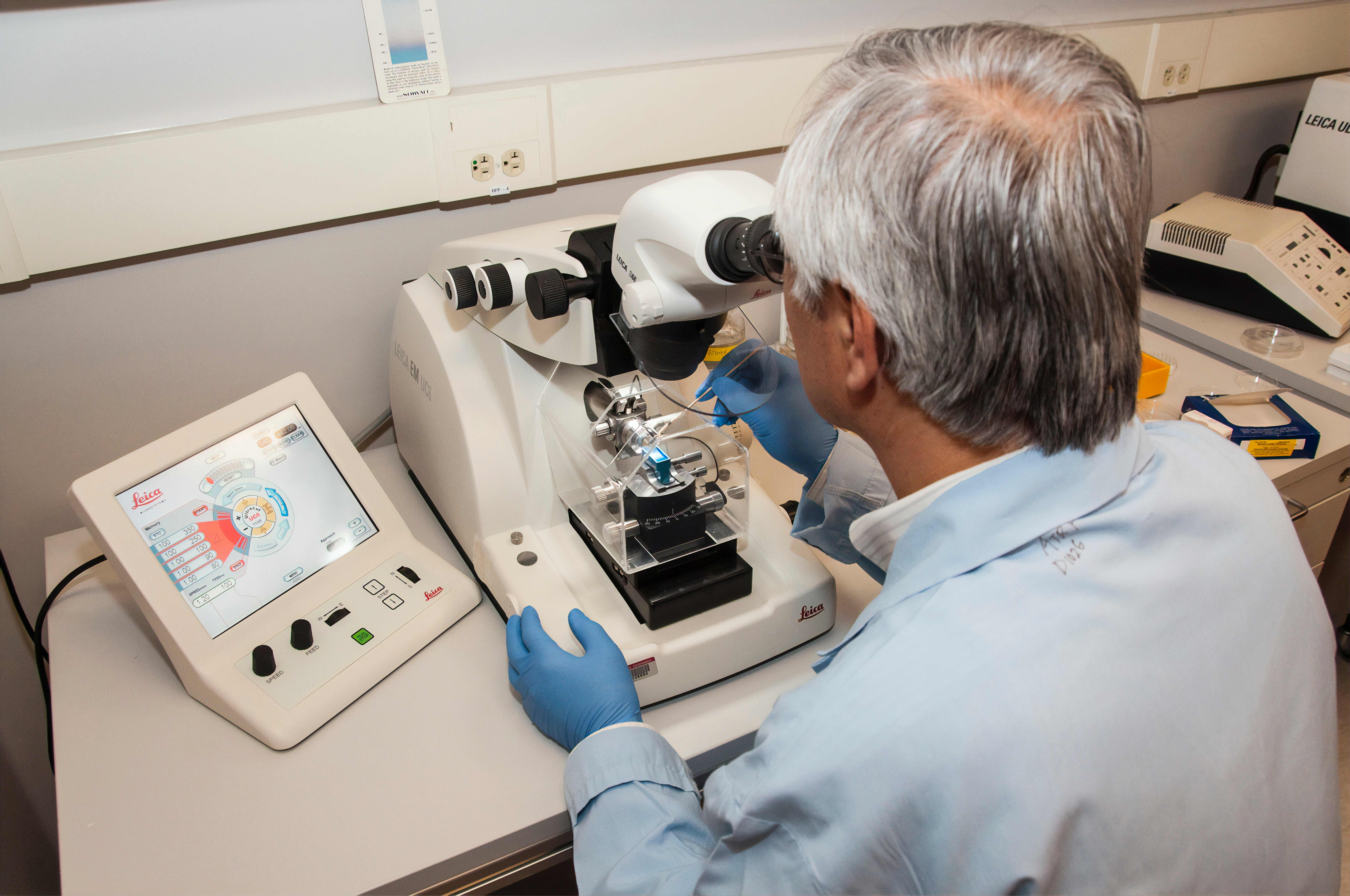 A technician using a microtome at the Advanced Technology Research Facility (ATRF), Frederick National Laboratory for Cancer Research, National Cancer Institute. A microtome is an instrument that cuts extremely thin sections of material for examination under a microscope.